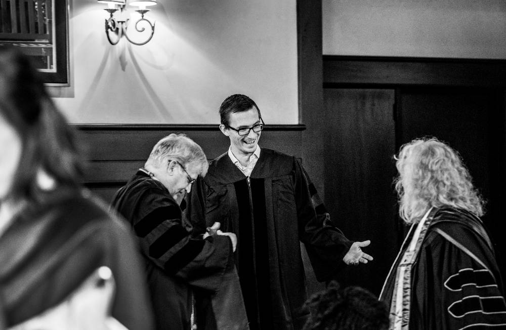Black and white picture of 3 faculty chatting